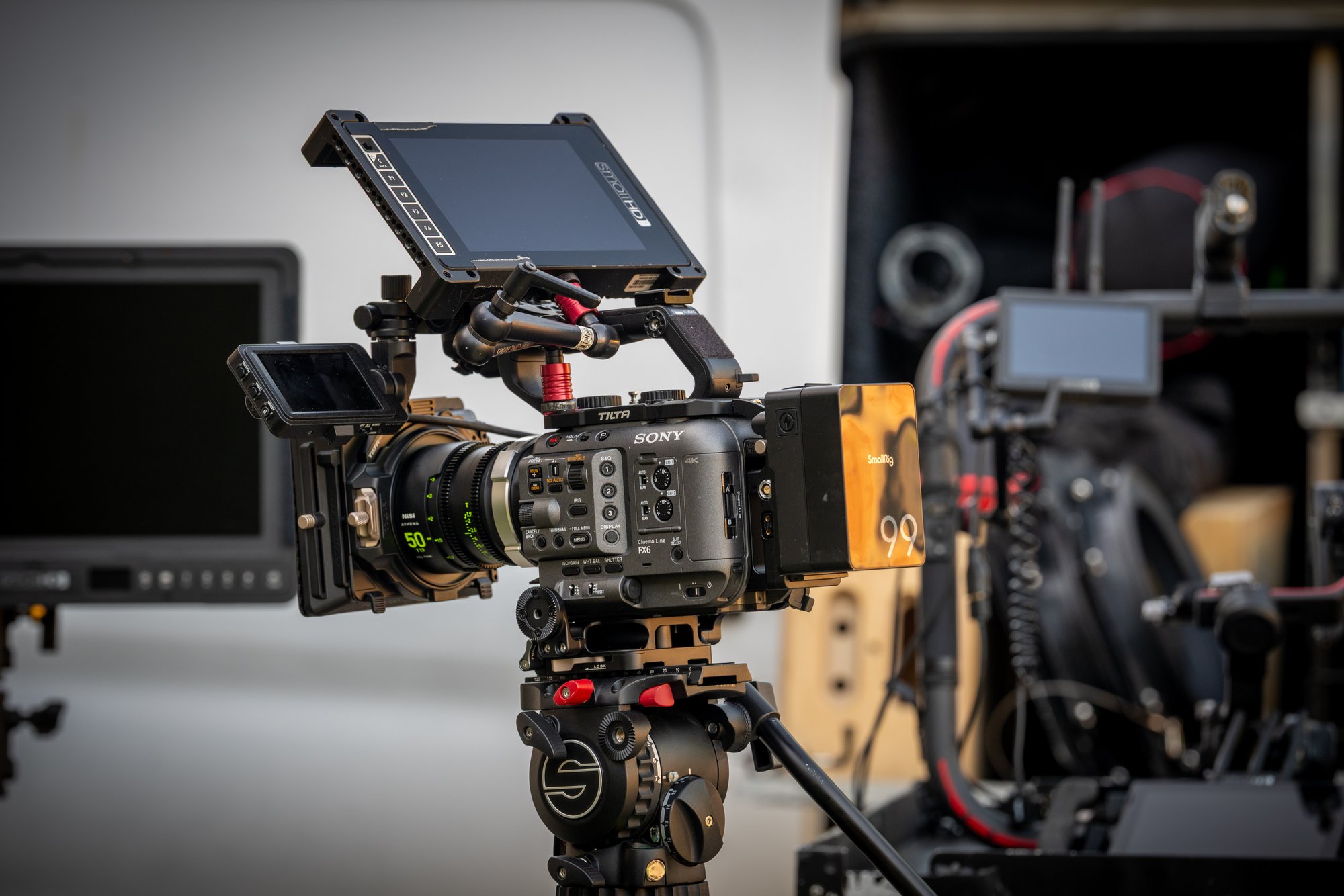 The Sony FX6 camera package built and staged: cinema lens, monitor, wireless focus control, and lens shade, rigged on a tripod at the van
